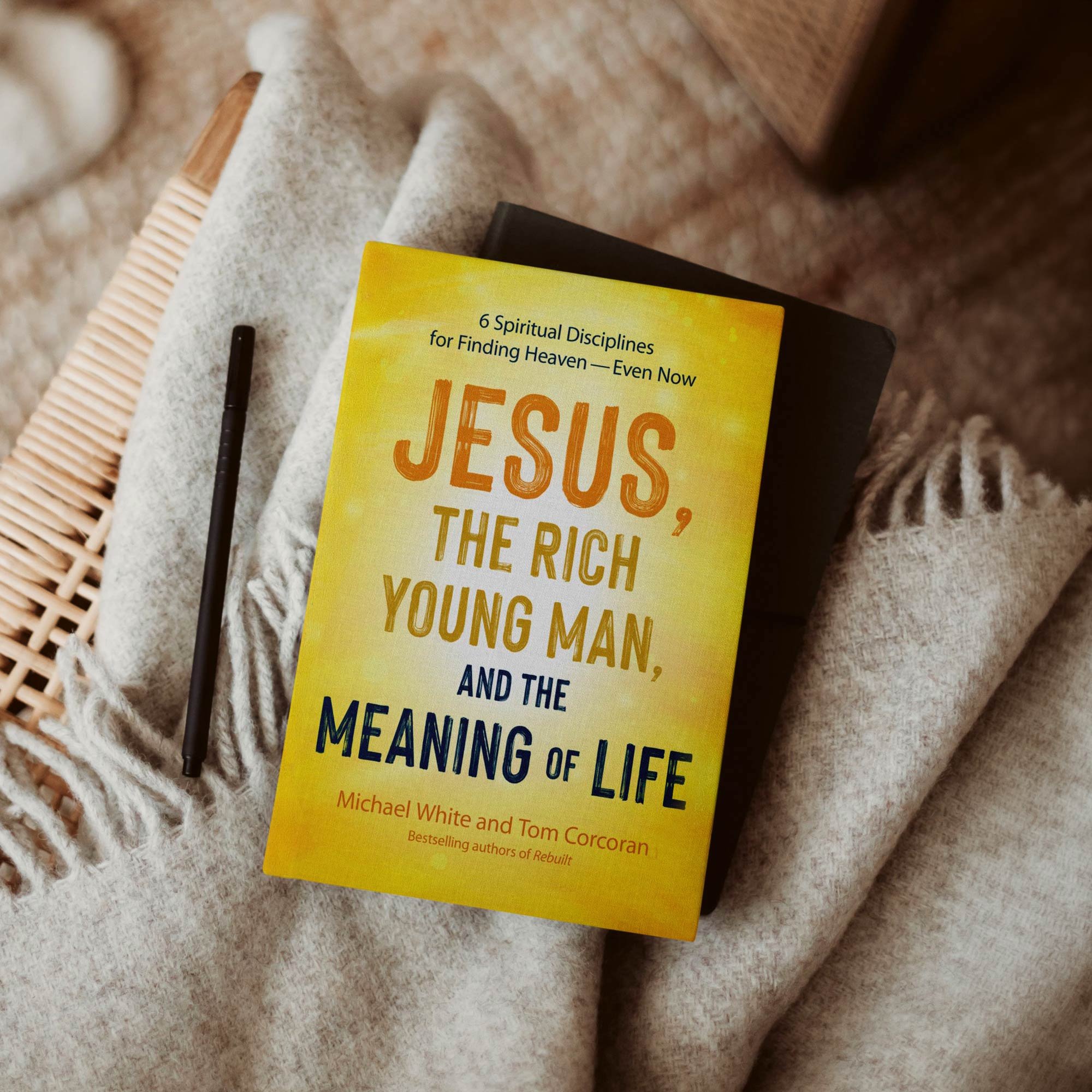 Jesus, the Rich Young Man book with a journal on a family room chair
